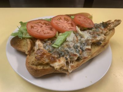 José’s Hoagie. This picture the pics grilled chicken with sautéed Mushrooms and onions, melted mozzarella cheese, lettuce and tomato on an open faced semolina sub Served on Johny’s countertop