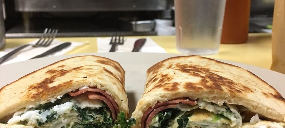 No 25 on a pita. This picture dick pics three egg whites, spinach and turkey bacon on a rolled up pita bread served on a white plate on Johnny’s counter