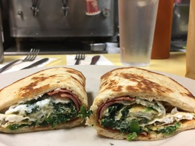 No 25 on a pita. This picture dick pics three egg whites, spinach and turkey bacon on a rolled up pita bread served on a white plate on Johnny’s counter